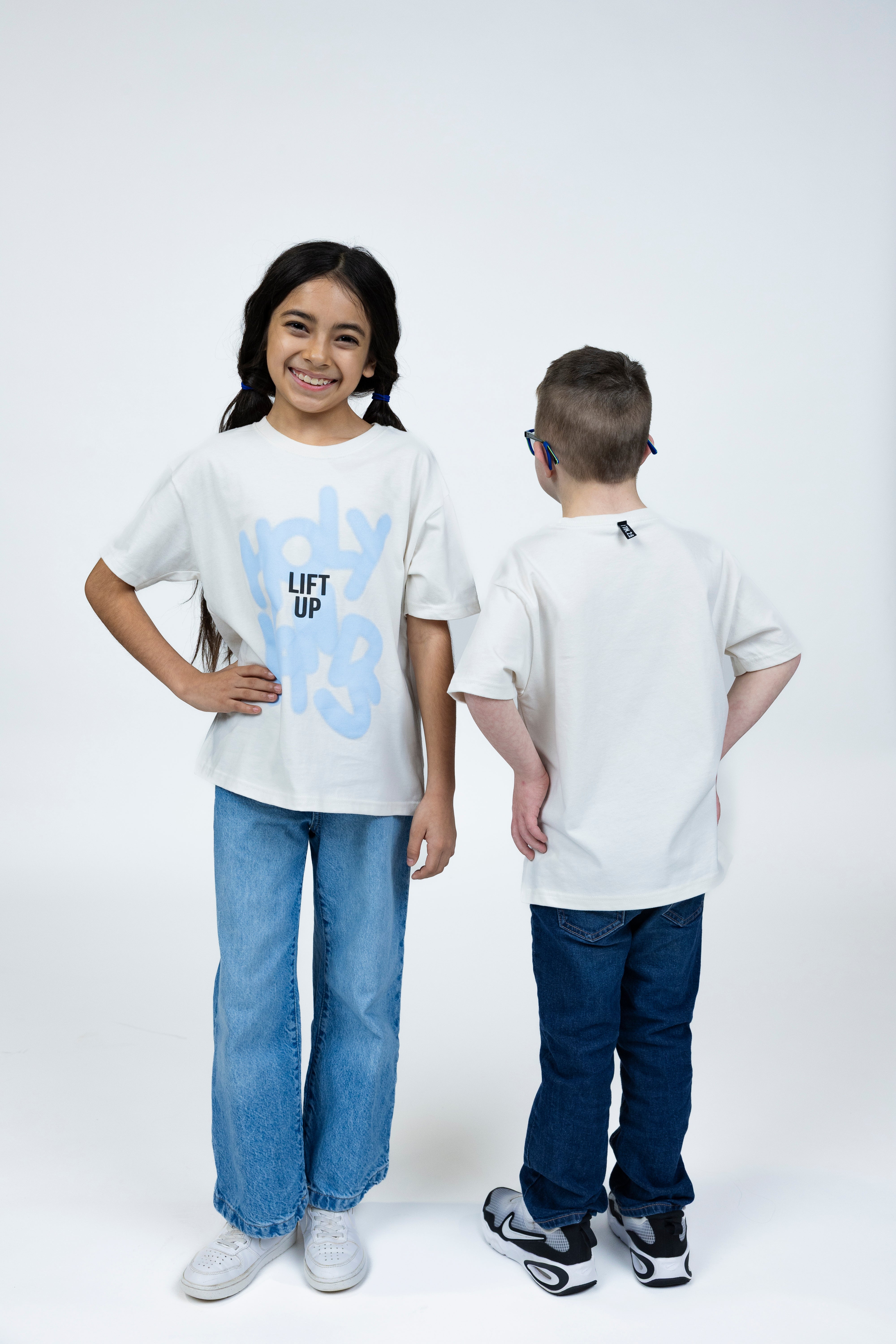 Penelope is wearing a size Youth L and Whitten is wearing a size Youth S